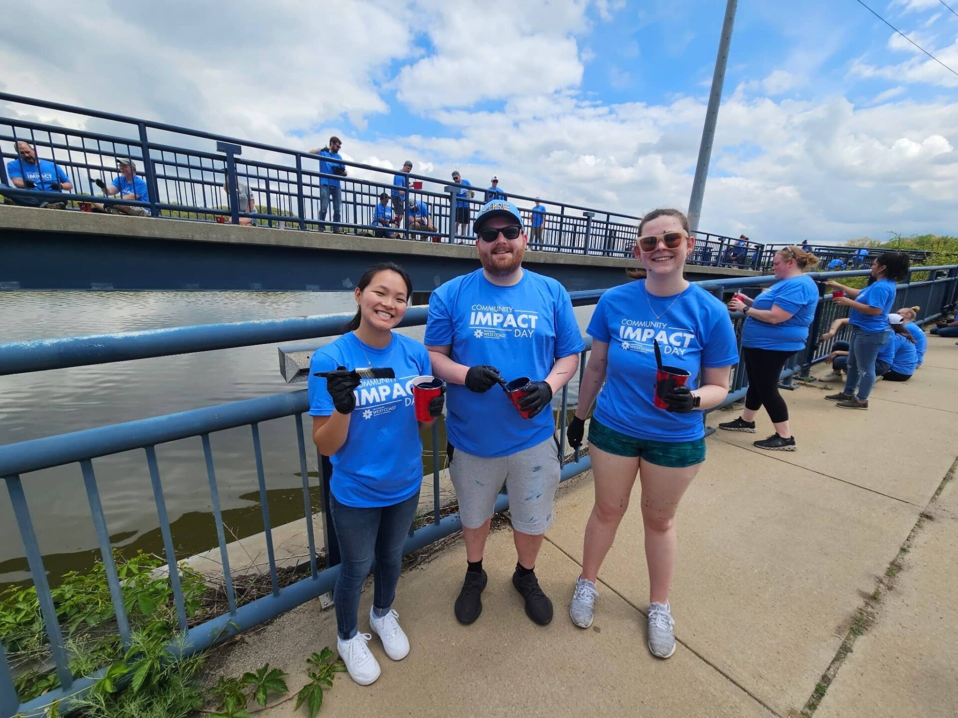 LG Energy Solution Michigan Talent Acquisition team paint a local bridge on Community Impact Day 2025